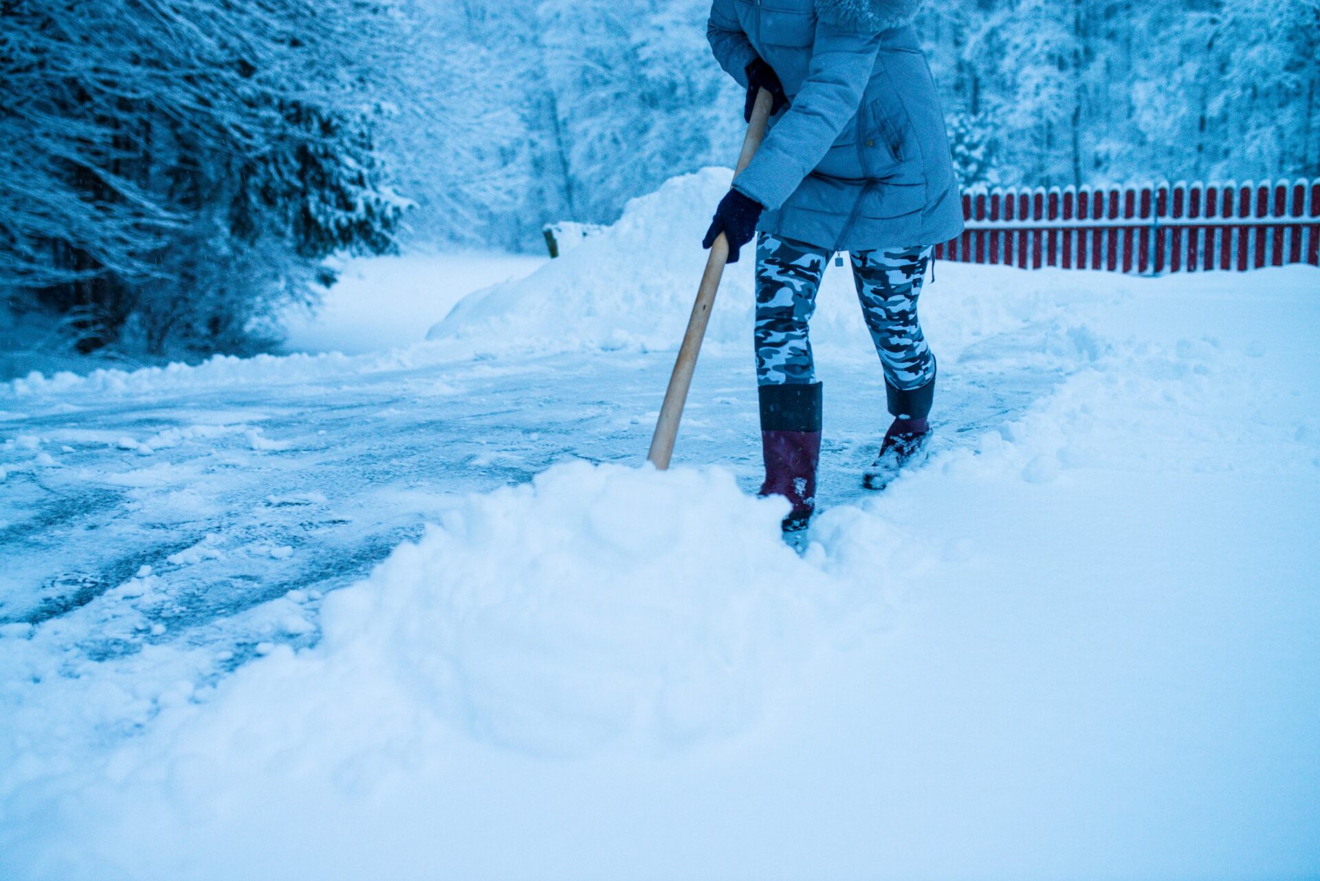 Person collecting snow during severe winter weather preparation.