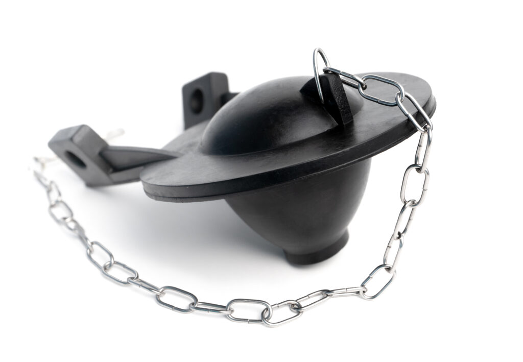 Replaced toilet flapper installed inside a toilet tank.