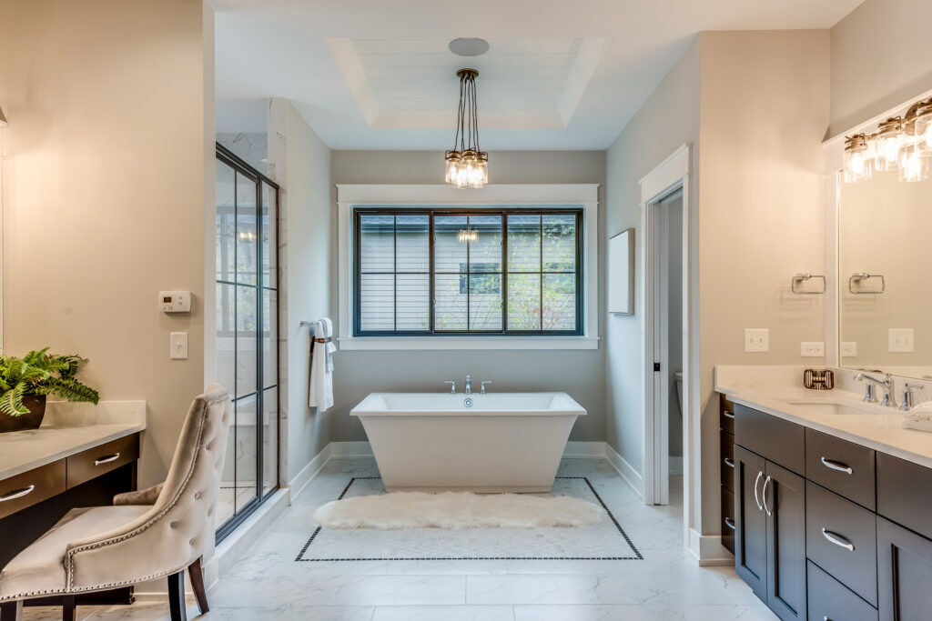 A modern bathroom featuring a freestanding bathtub near a large window.