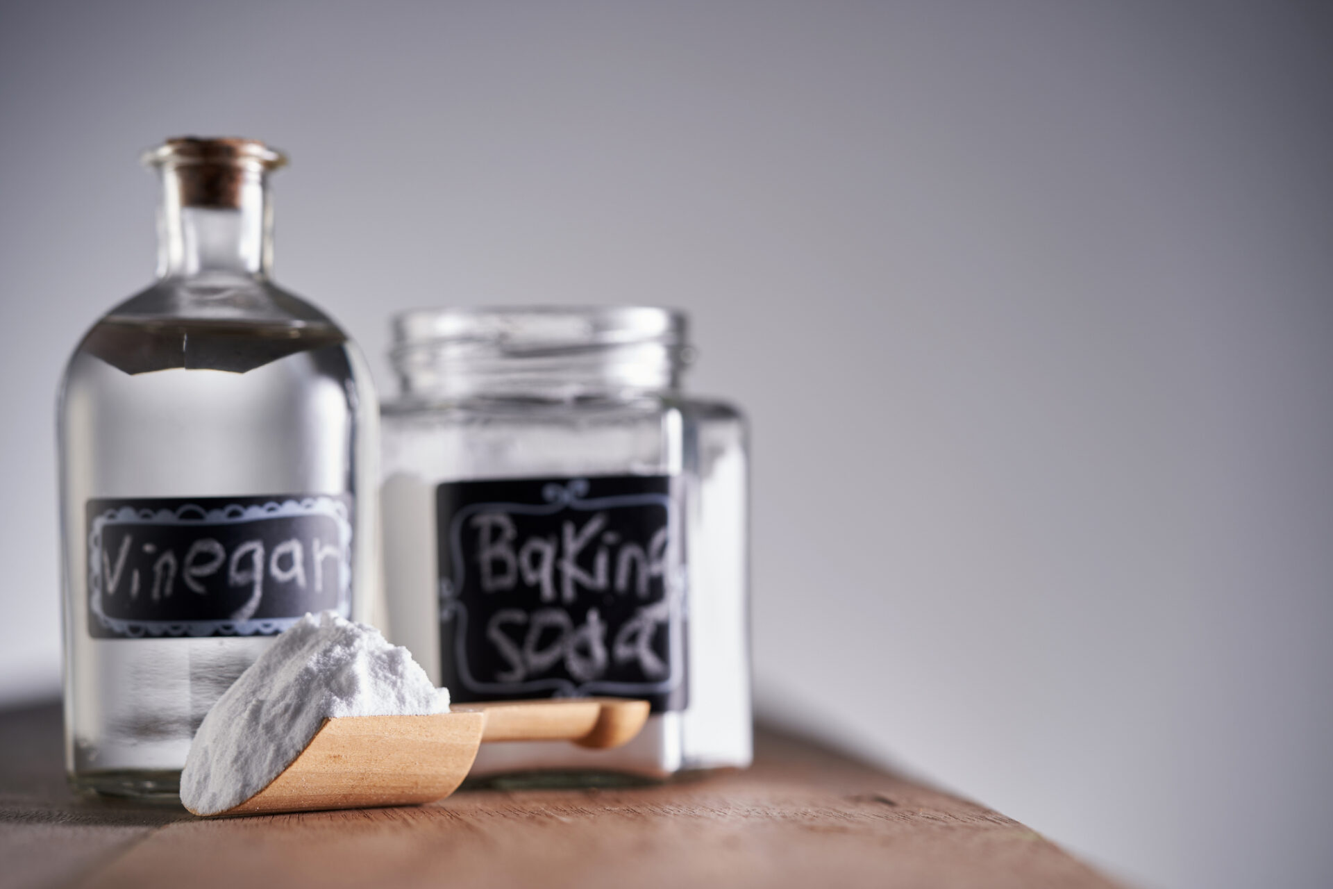 Natural drain cleaning using vinegar and baking soda fizzing in a sink drain.