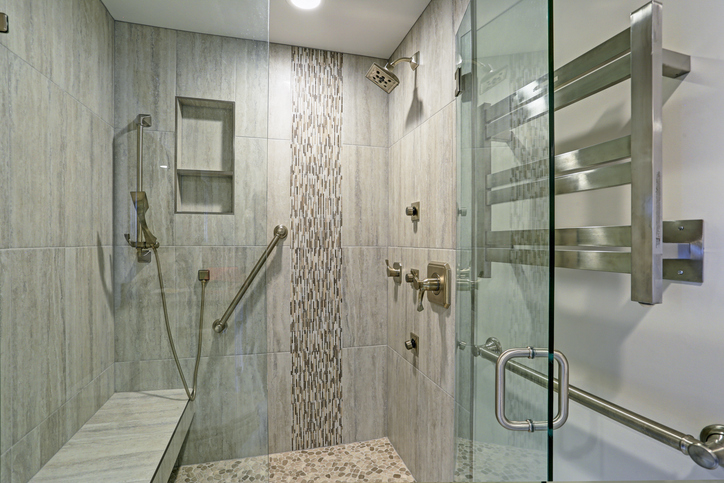 Modern bathroom with safety features including grab bars, non-slip flooring, and well-lit spaces.