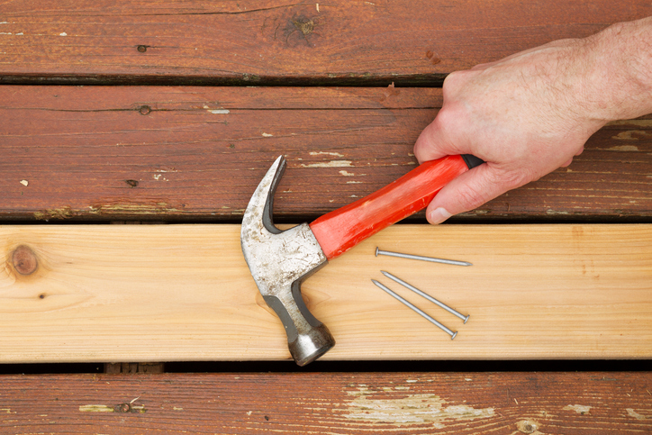 Repairing old wooden boards on deck, home maintenance