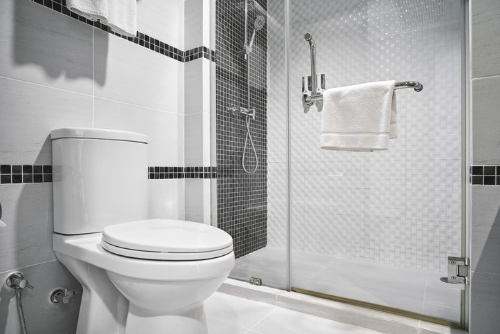 Modern remodeled bathroom with sleek fixtures, tiled walls, spacious shower, and contemporary lighting features.