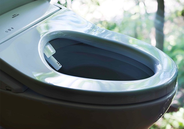 Bidet toilet seat installed on a modern bathroom toilet