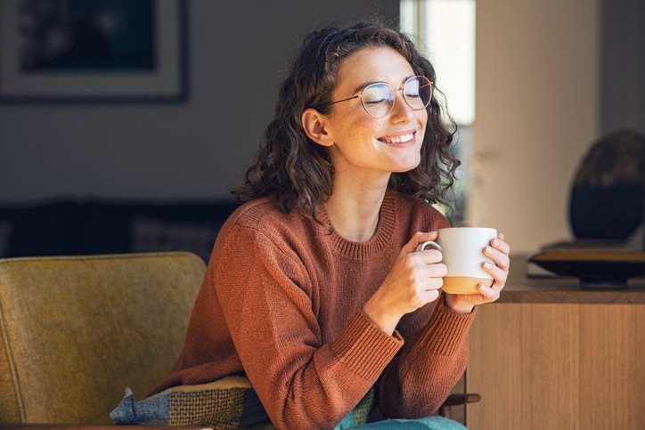 Girl sitting in furnace room, enjoying tea and feeling relaxed