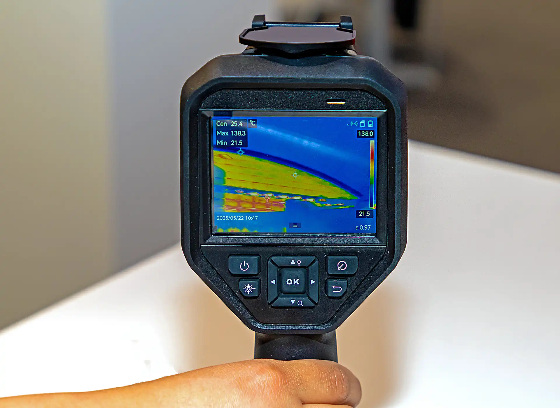 Close-up of thermal imaging camera display showing heat map during leak detection