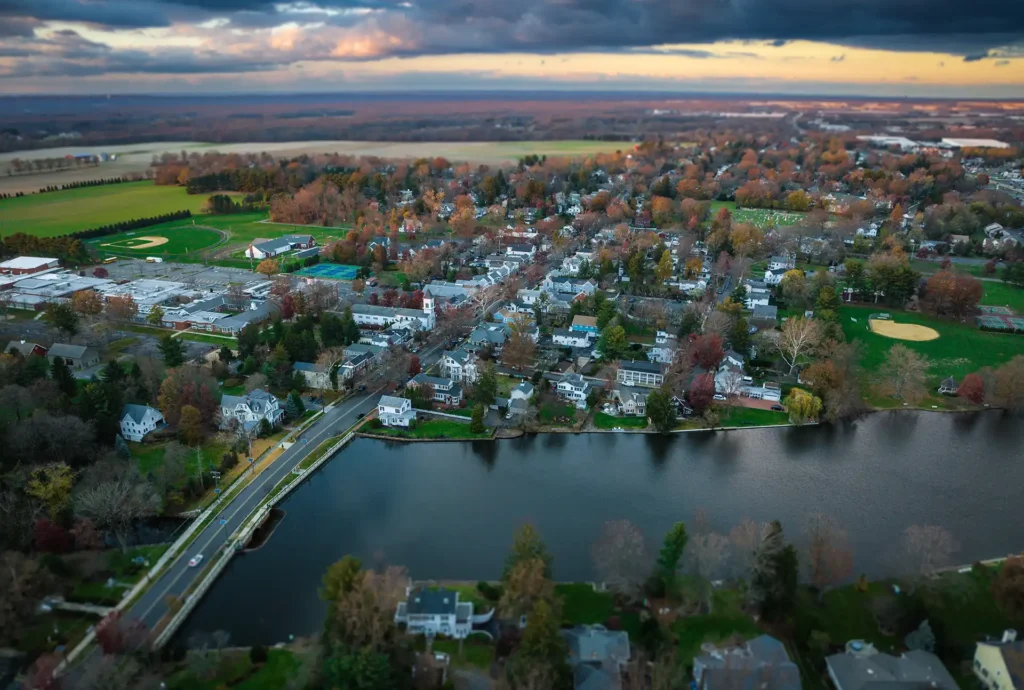 Aerial view of Cranbury, New Jersey waterside neighborhood with fall foliage