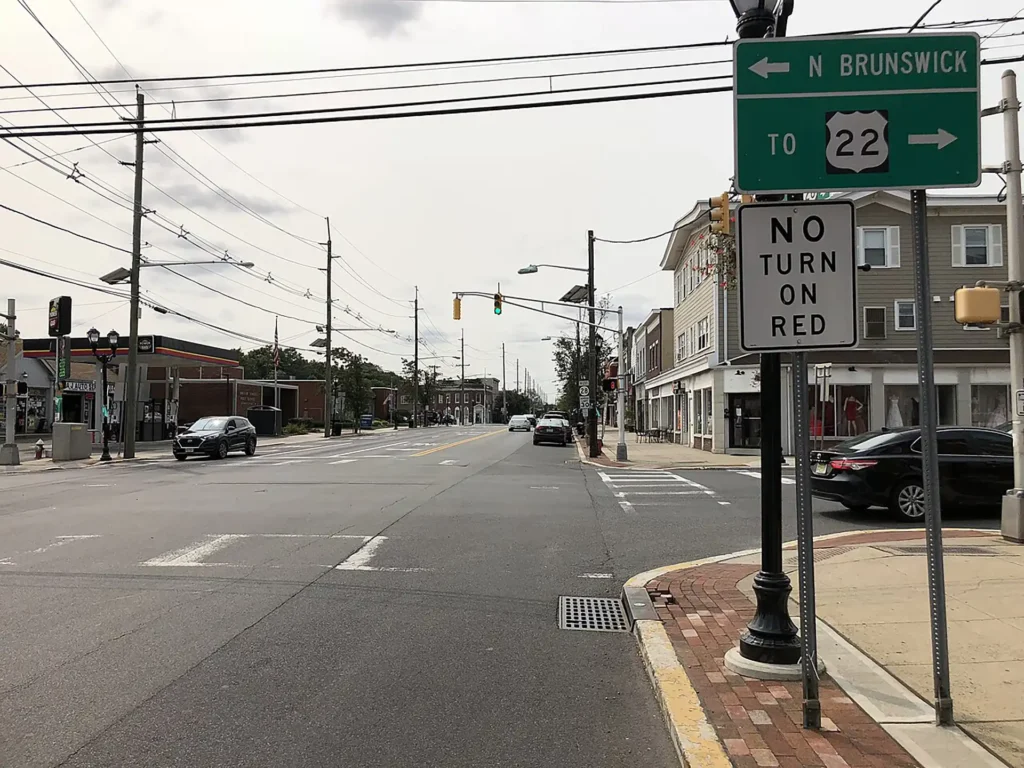 Downtown Dunellen, New Jersey main street with shops, traffic lights, and road signs toward North Brunswick and Route 22
